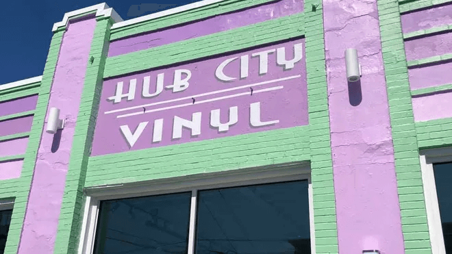 A pastel green and purple brick building with 