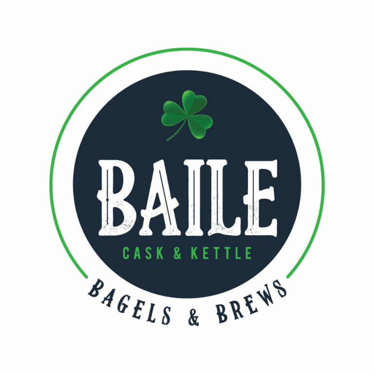 A circular logo with a green shamrock above bold white text reading 