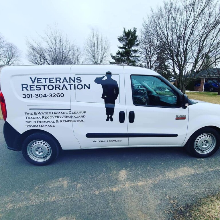 Veterans Restoration Van. A white van with their logo on the side of it.