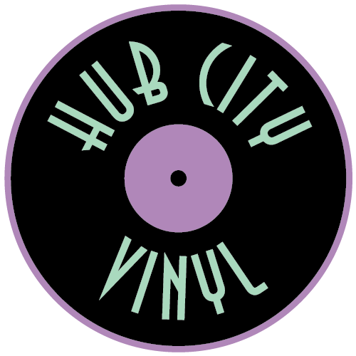 A black vinyl record with a purple label and border features the words 