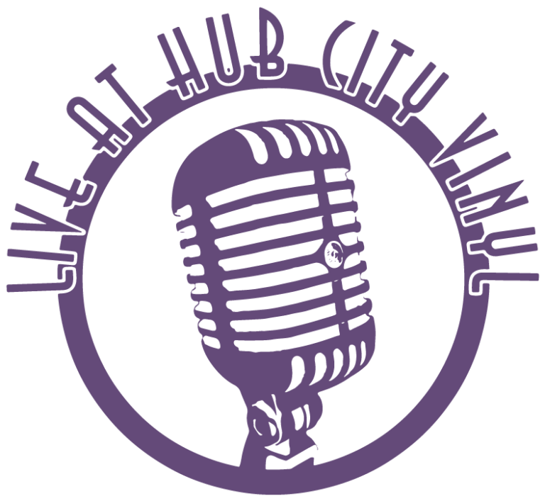 A circular logo with a large vintage microphone in the center and the words “Live at Hub City Vinyl” curved around the top edge, all in a purple color.