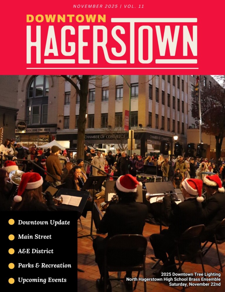 A festive crowd gathers on Main Street for the 2025 Downtown Tree Lighting as a band in Santa hats performs. The Downtown Hagerstown magazine cover, like the newsletter, highlights updates, events, and local features.