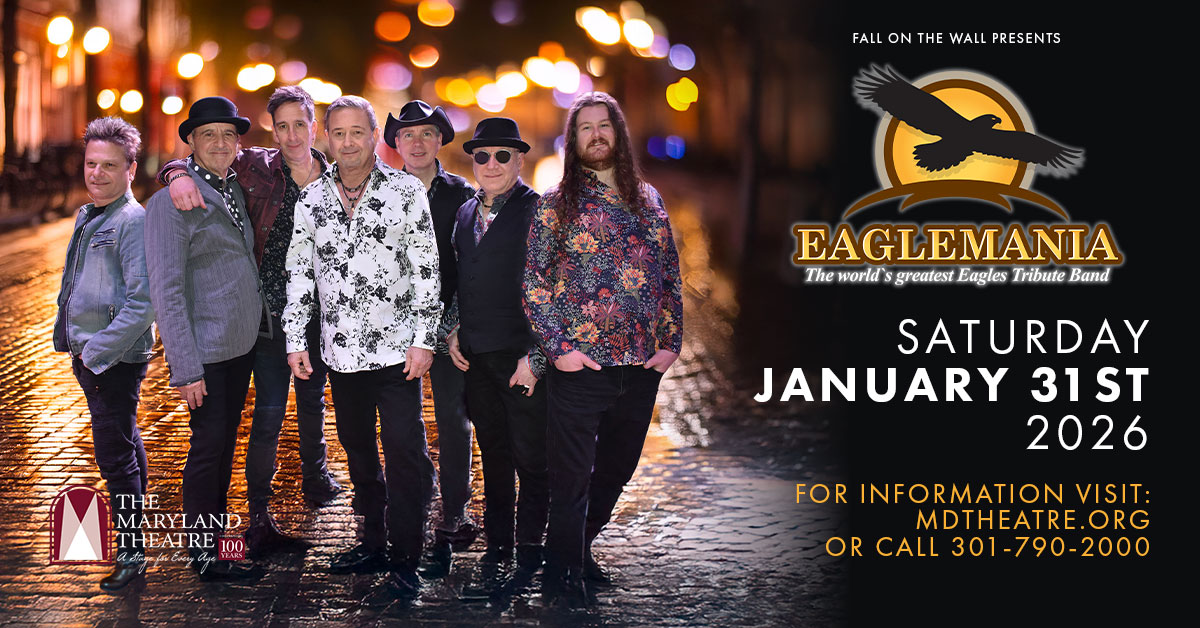 A group of eight men in casual and stage attire stand together on a lit street. Text reads: "Eaglemania, the world’s greatest Eagles tribute band, Saturday January 31st 2026, Maryland Theatre. Visit mdtheatre.org or call 301-790-2000.
