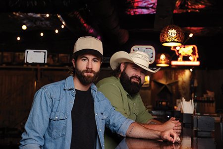 Two men wearing cowboy hats.