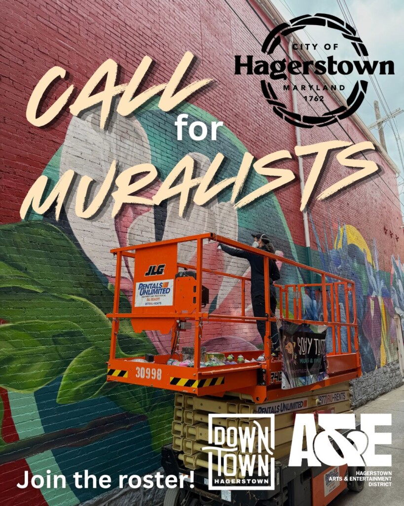 A person on a lift painting a large colorful mural on a brick wall. Text reads, "Call for muralists. Join the roster!" City of Hagerstown, Downtown Hagerstown, and A&E logos shown.