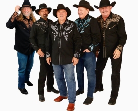 Five men in black cowboy hats and Western-style shirts posing together against a white background.