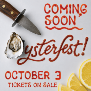 A knife, an oyster, and lemon wedges surround text written in red sauce: “COMING SOON: Oysterfest! October 3 TICKETS ON SALE.”.